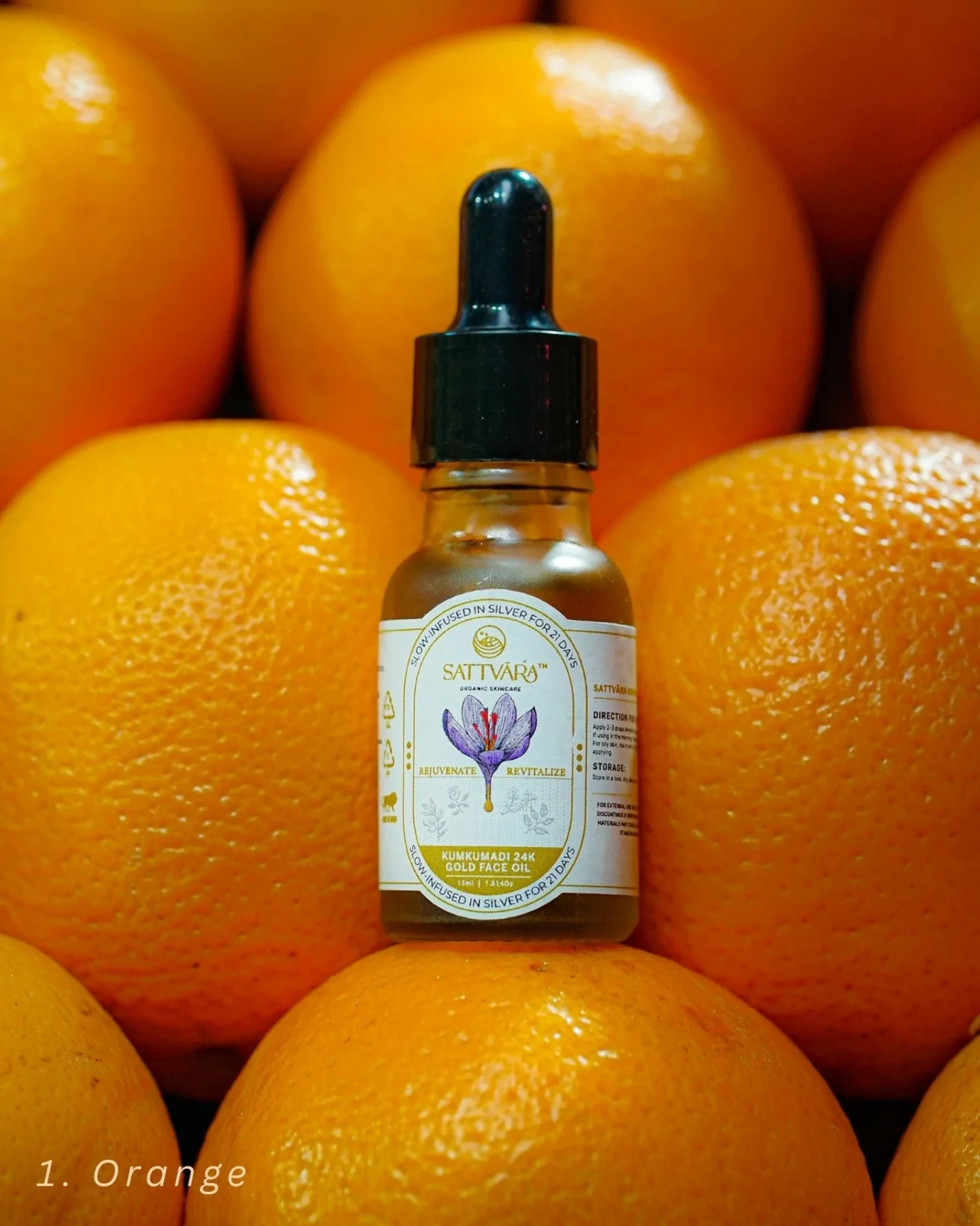 The Sattvāra face oil bottle resting among fresh oranges.