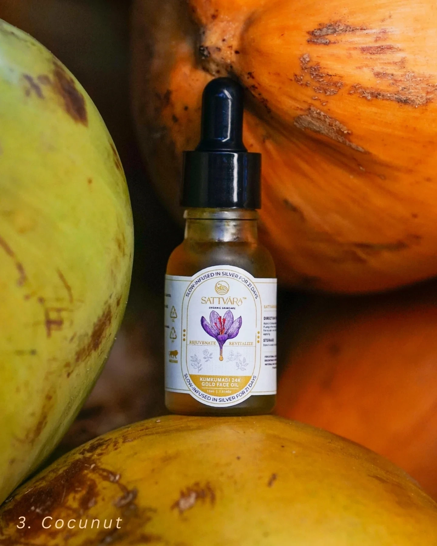 The Sattvāra face oil bottle beside halved coconuts.