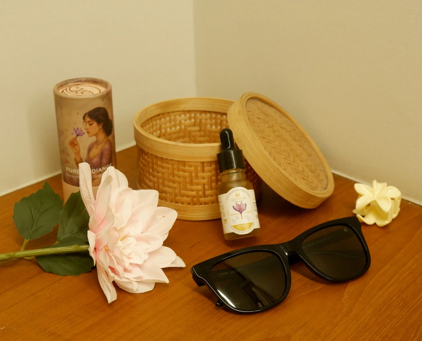 Flat lay of the Sattvāra face oil bottle and packaging.